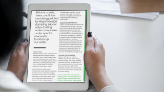 Person holding ipad reading UK General Election Labour Party manifesto