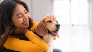 Woman smiling with beagle dog